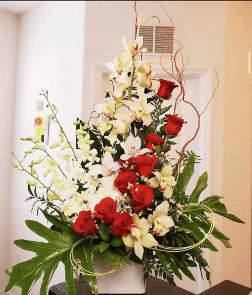 Cymbidium Orchids With Red Roses