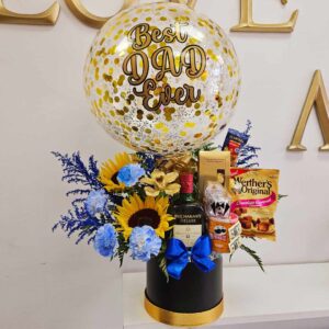 Personalized Flower Arrangement decorated with beautiful Sunflowers, Golden Orchids, Blue Carnation, filled with goodies and a Bottle of Whiskey (750ml) Decorated with a Beautiful Personalized Ballon