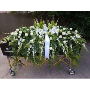 White Dendrobium Orchids Roses Lillies and more. Make this a true beauty for your loved one.