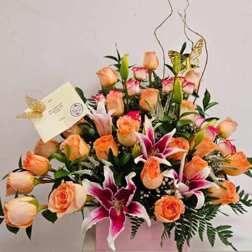 This Stunning and vibrant Sunset Bouquet. Is a fresh arrangement of orange , pink & pink Stargazer lilies, assorted greenery and curly willow for a contemporary flair