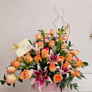 This Stunning and vibrant new Sunset Bouquet. A fresh arrangement of orange , pink & pink Stargazer lilies, assorted greenery and curly willow for a contemporary flair