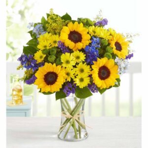 This bouquet is gathered with fresh-picked blooms, revealing the rustic beauty of nature. Shades of golden yellow and rich blue pop against lush greenery