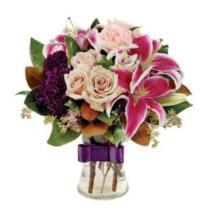 This provocative combination of Stargazer lilies, pink and Sahara roses, purple carnations, magnolia leaves and eucalyptus